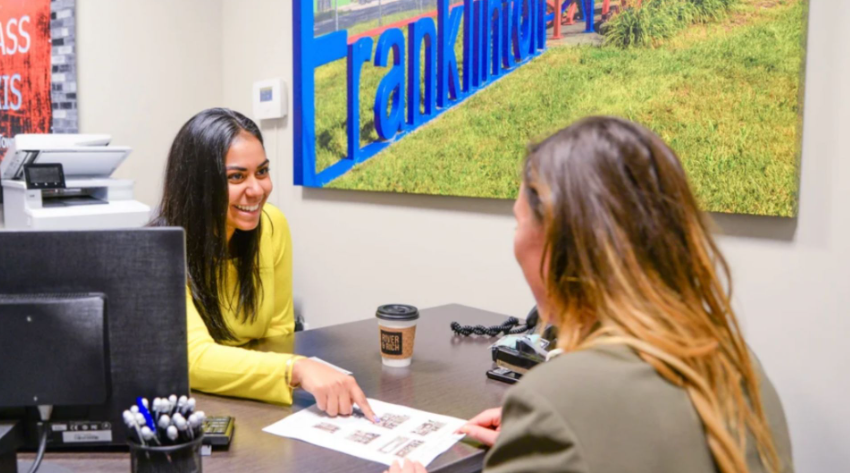 Oakwood leasing team member meeting with a prospective resident at an Oakwood apartment community.