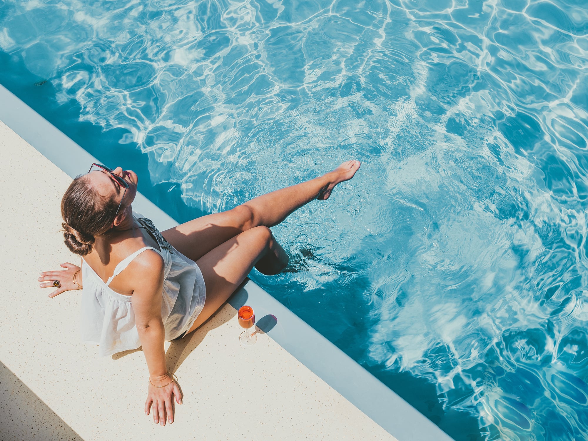 Woman sitting by pool