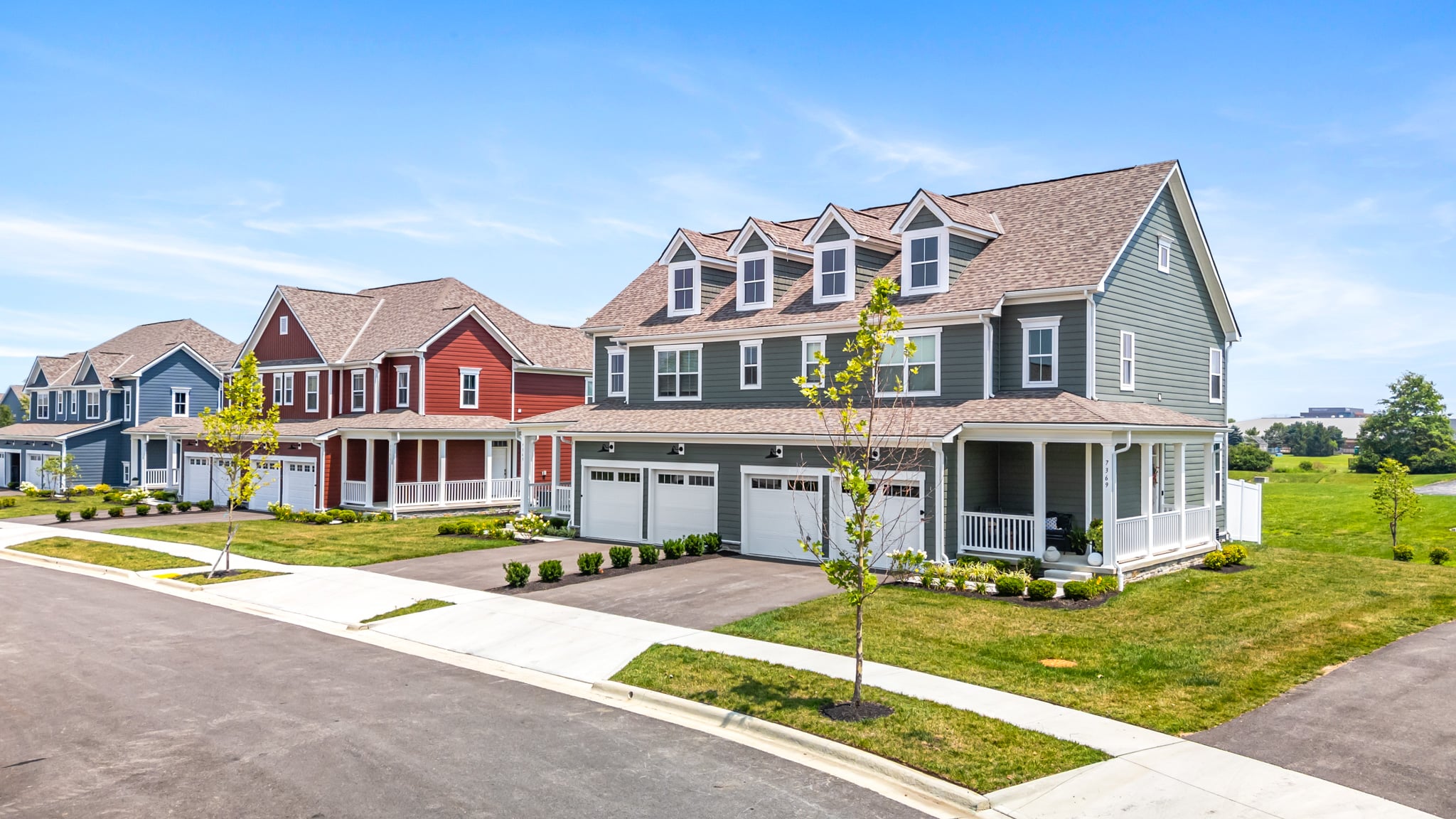 Liberty Reserve apartments in Powell, Ohio featuring attached garages with modern townhome style layouts and private driveway parking.