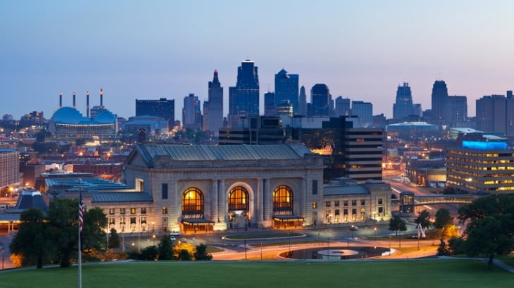 view of downtown KC's skyline on a summer night, with union station in the foreground