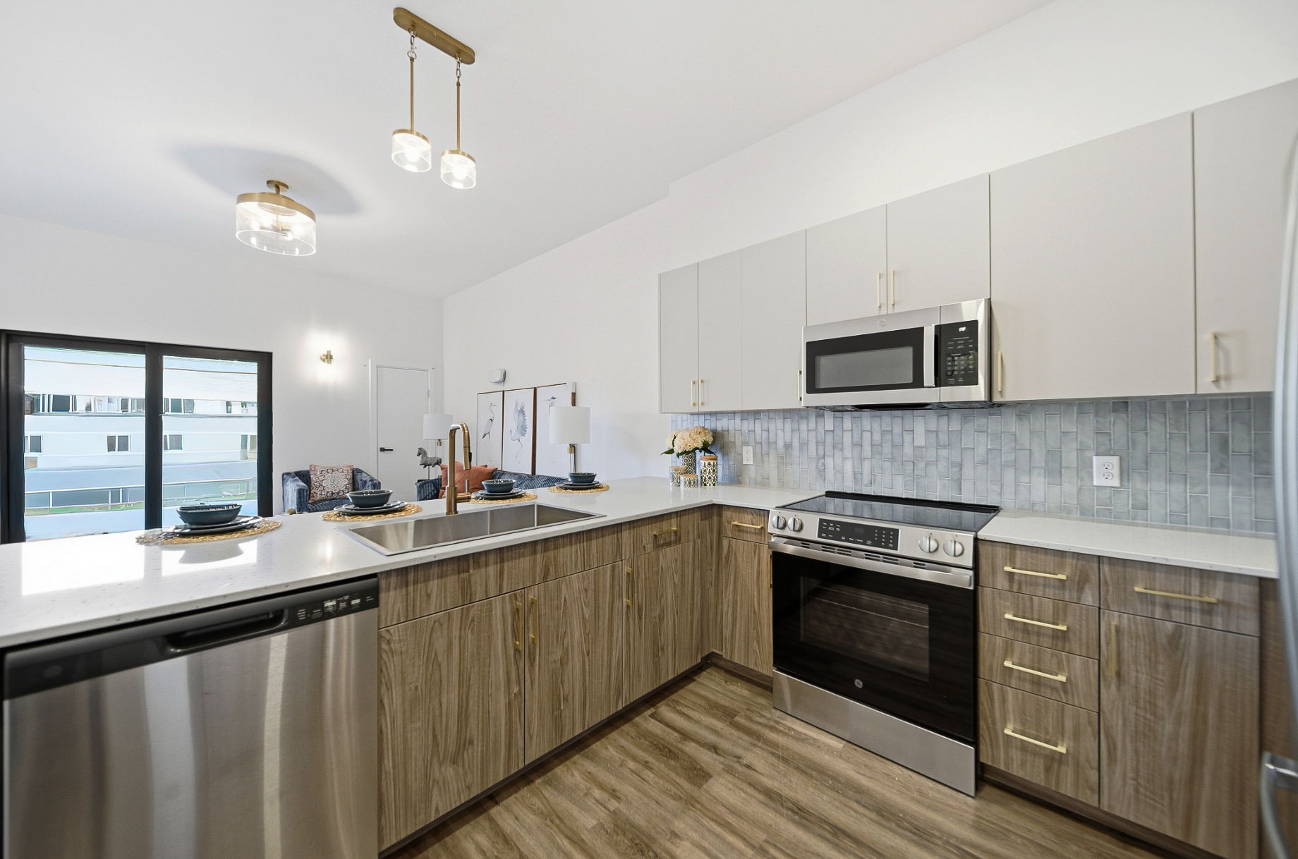 Modern kitchen inside an apartment at Webstar Station Flats in Dayton, Ohio, featuring an open floor plan and contemporary finishes.