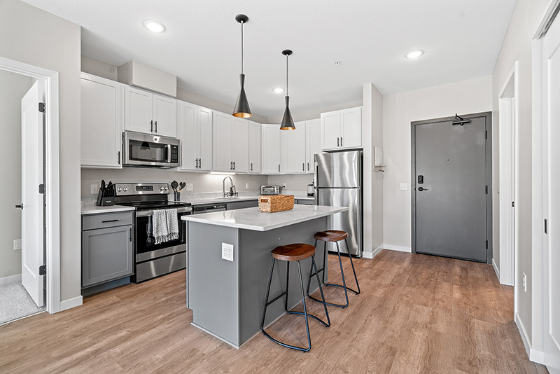 Modern kitchen with stainless steel appliances at The Lodge at Overland Apartments near Mayo Clinic Rochester MN