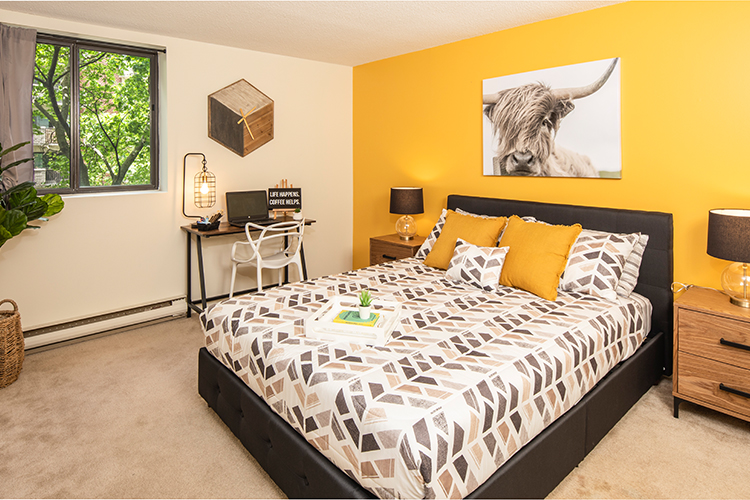 Image of a bedroom with yellow accent wall