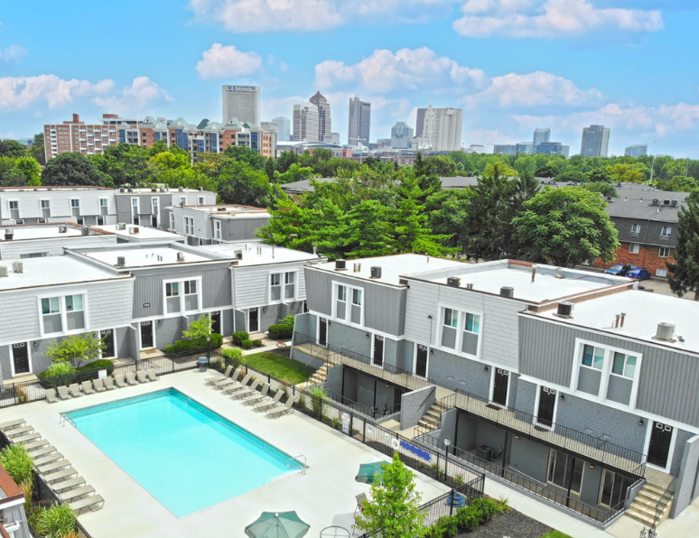  Aerial view of Sonnenblick apartments with resort-style pool and downtown Columbus skyline in the distance.