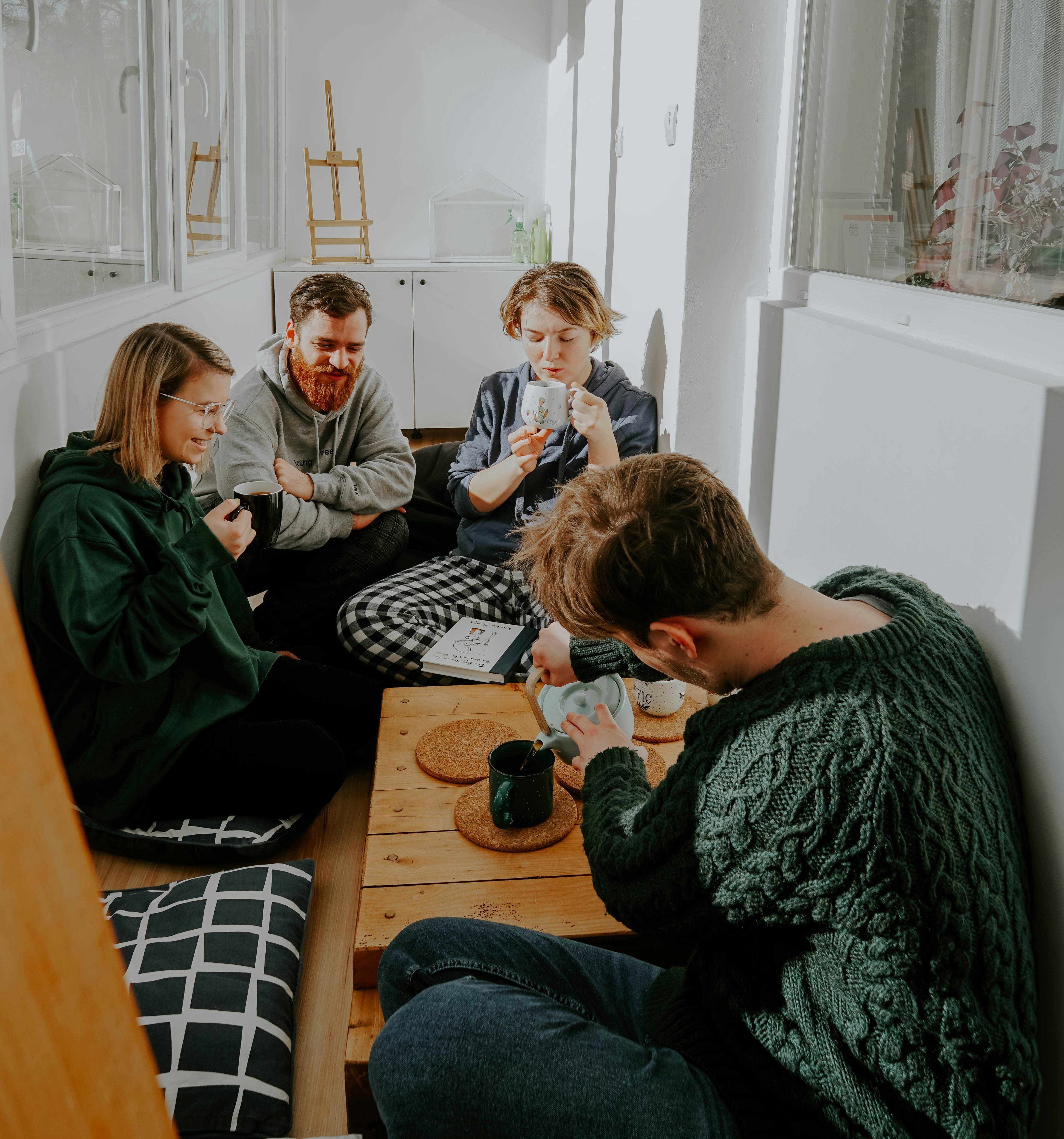 friend group socializing and laughing over tea