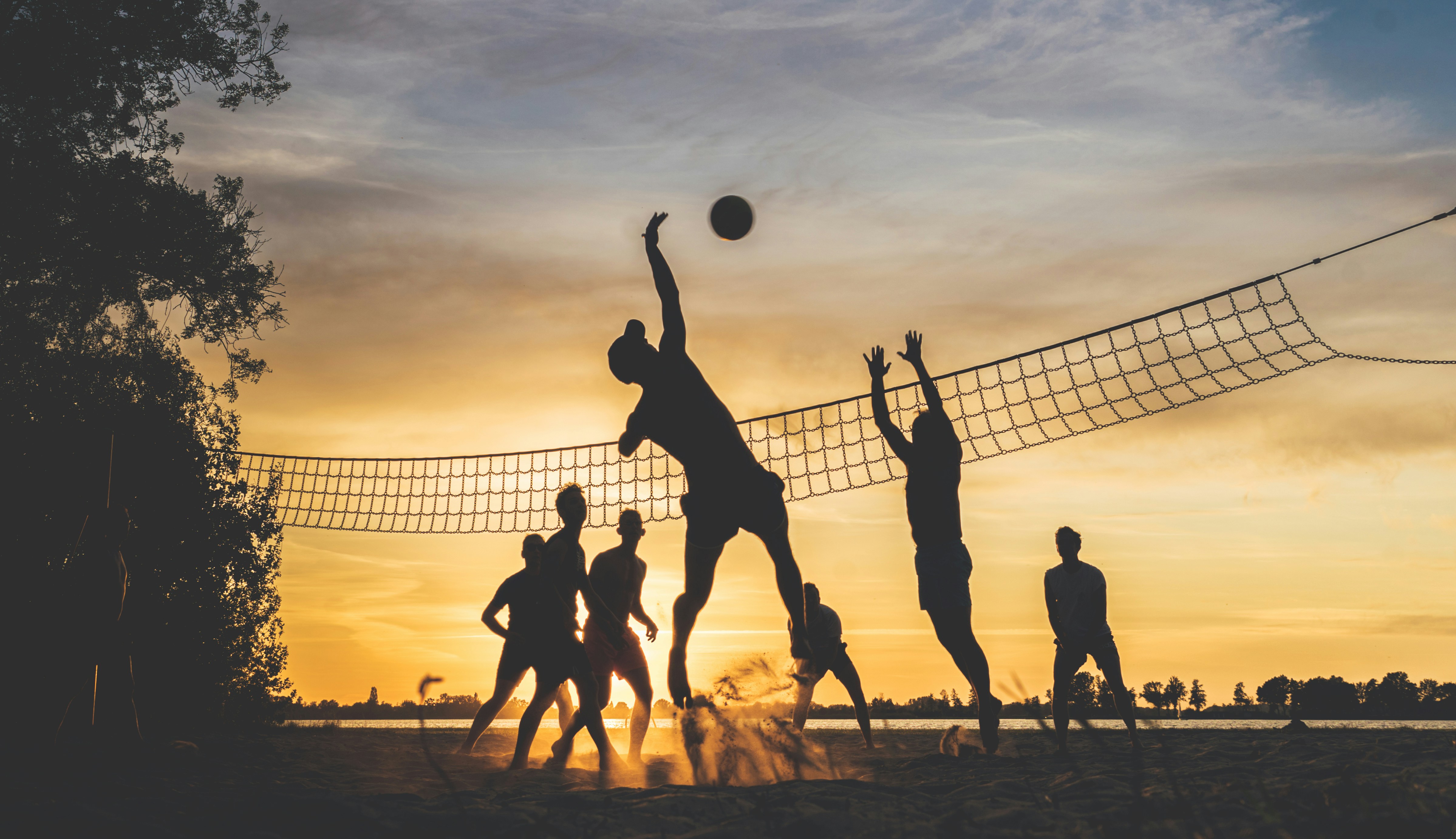 Playing volleyball at sunset