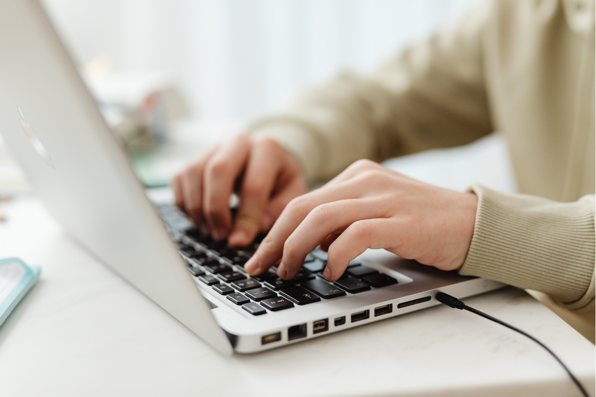 Remote worker enjoying a quiet workspace with a laptop and coffee in a comfortable home setting.
