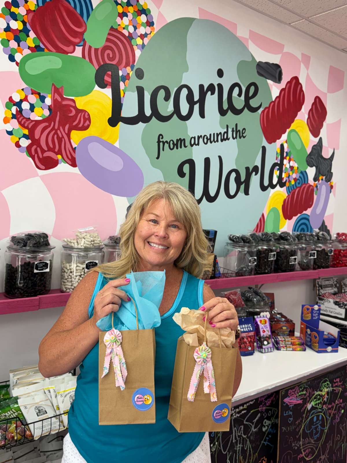 Cathy Paul, owner of Hello, Sweetz, in front of the licorice wall in Downtown New Port Richey