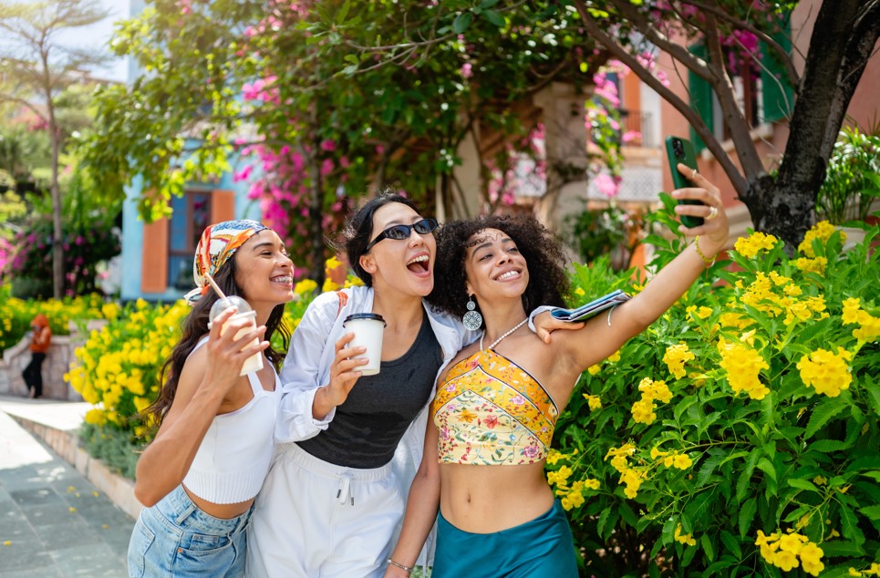 Three friends taking a selfie outdoors in New Rochelle on a sunny summer day