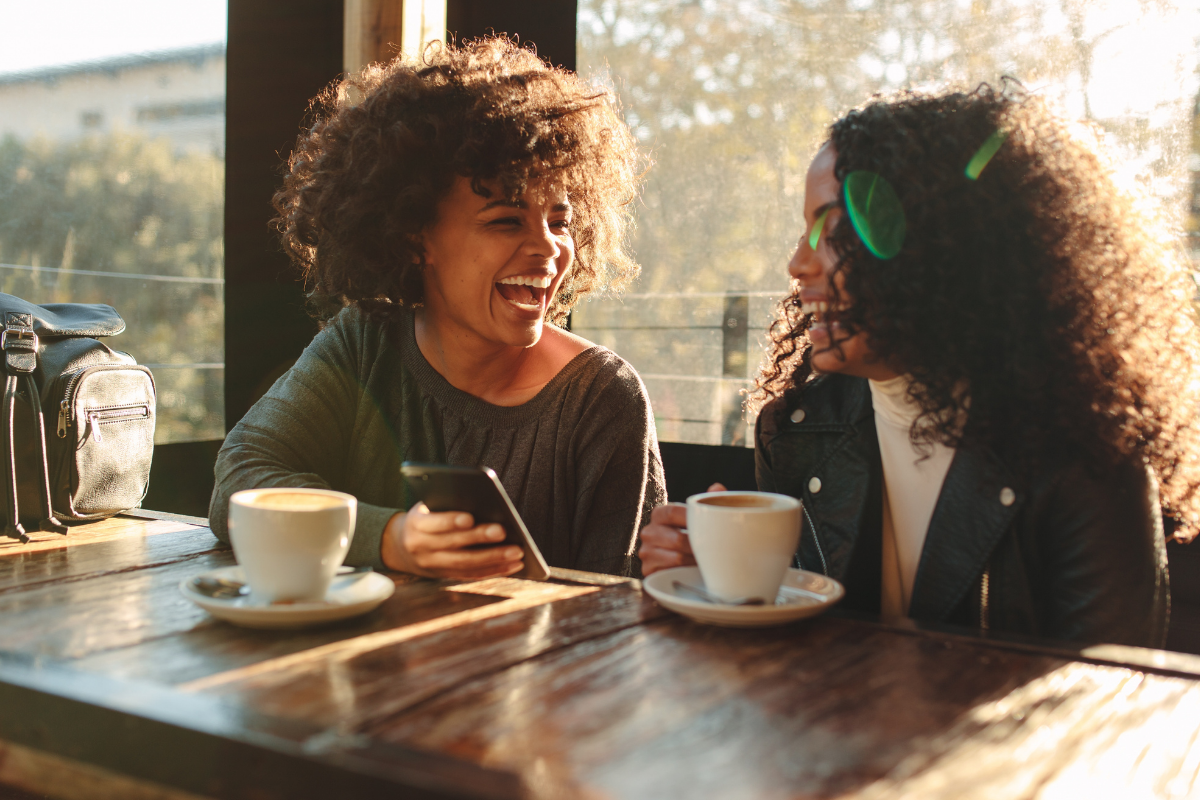 Two people sitting at a local coffee shop, enjoying a relaxed conversation that reflects everyday life in Dayton, Ohio.