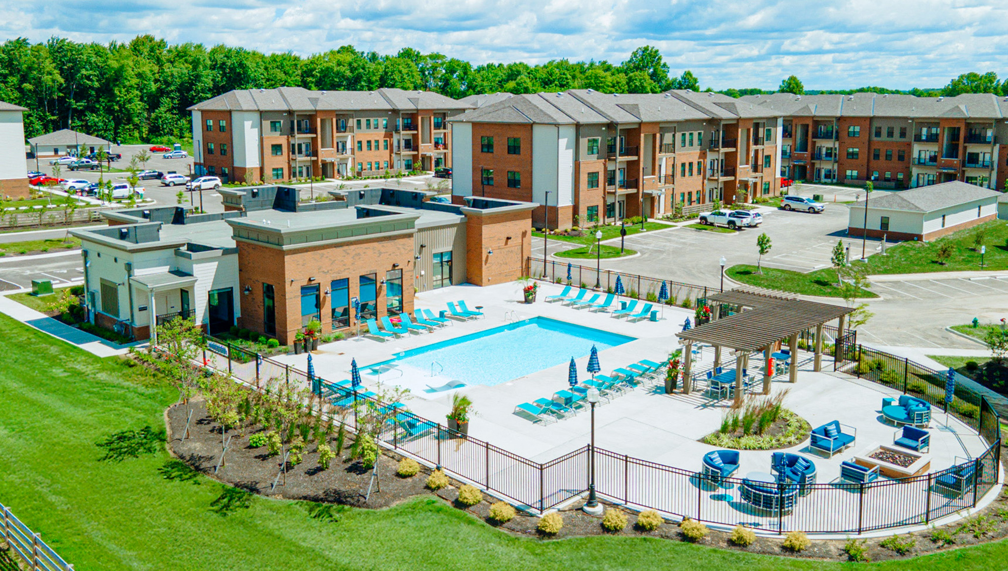 Aerial view of the resort-style pool, pergola lounge, and modern clubhouse at Northstar Flats Apartments in Sunbury, Ohio.