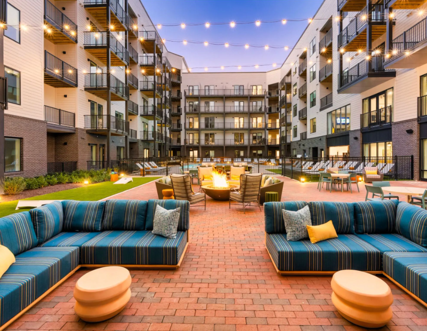 Courtyard with fire pit, pool, and outdoor lounge seating at The Galaxy at Polaris apartments in Columbus, Ohio.