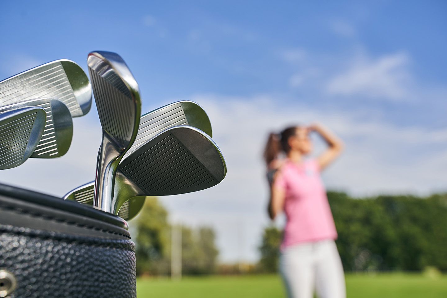 Girl Standing next to Golf Bag