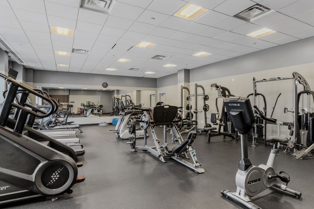 Sleek fitness center at Highpoint on Columbus Commons apartments in downtown Columbus with cardio and weight equipment.
