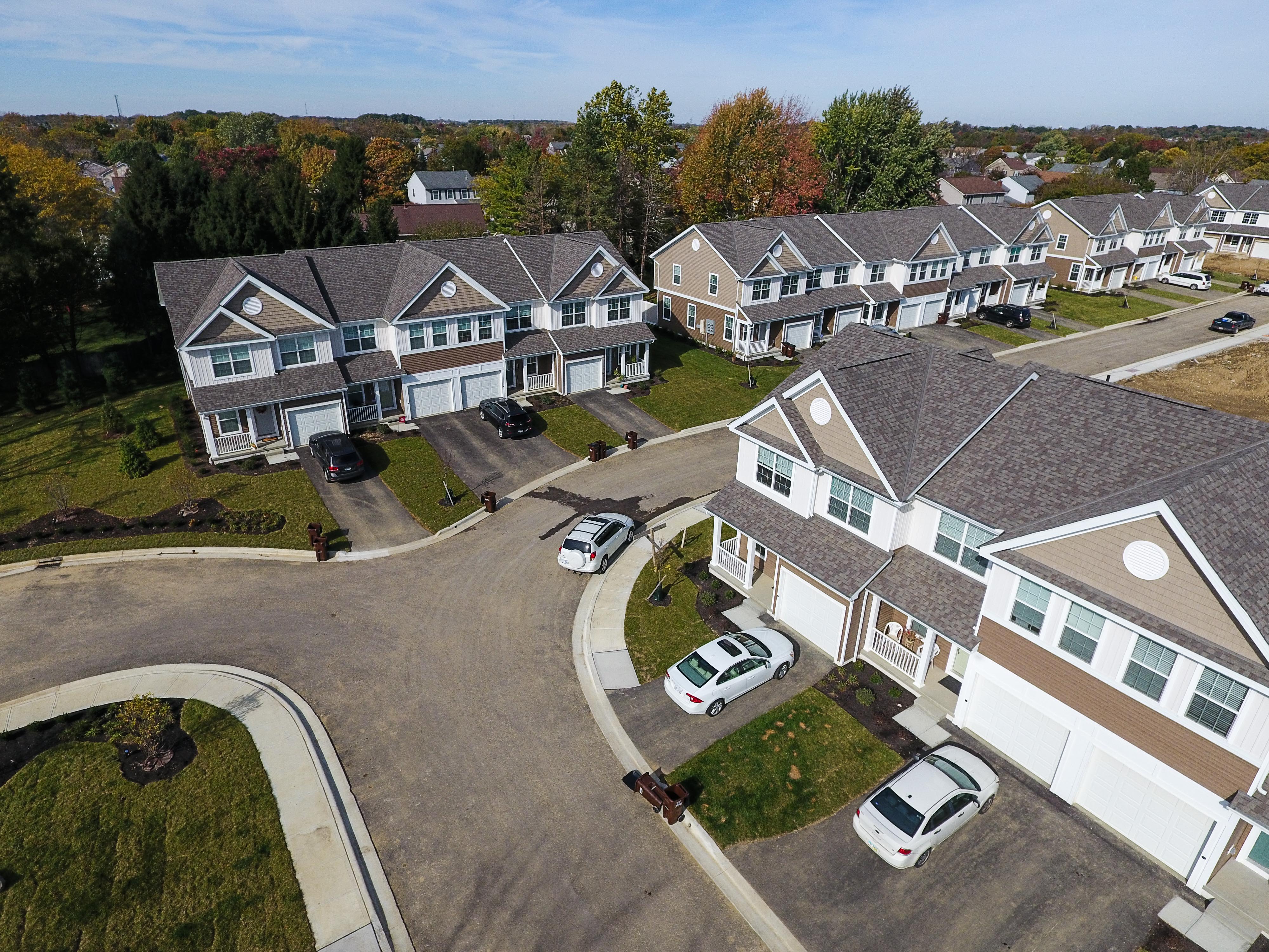 Hilliard Place townhomes in Hilliard, Ohio featuring attached garages, private entrances, and landscaped community signage.