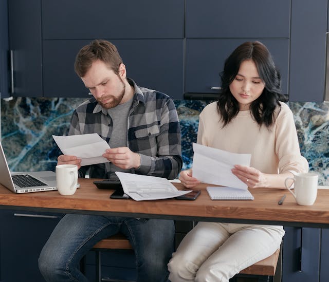 Finding the Perfect Apartments Near Mayo Clinic Rochester MN starts with setting your budget, like this couple reviewing their finances in a modern living area.