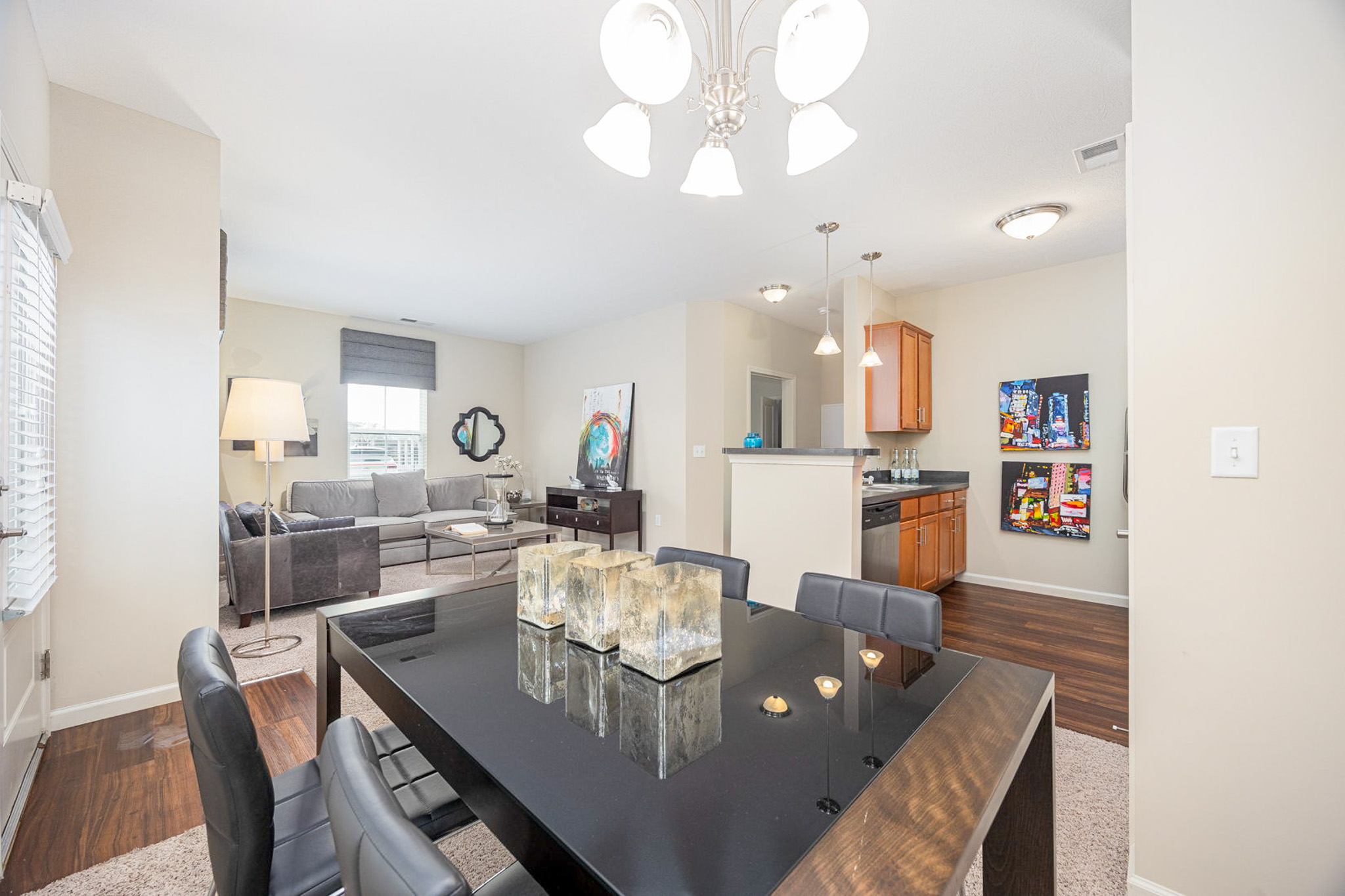 Open-concept living and dining area at Polaris Place apartments in Columbus, Ohio, featuring modern finishes, a spacious layout, and a breakfast bar kitchen.