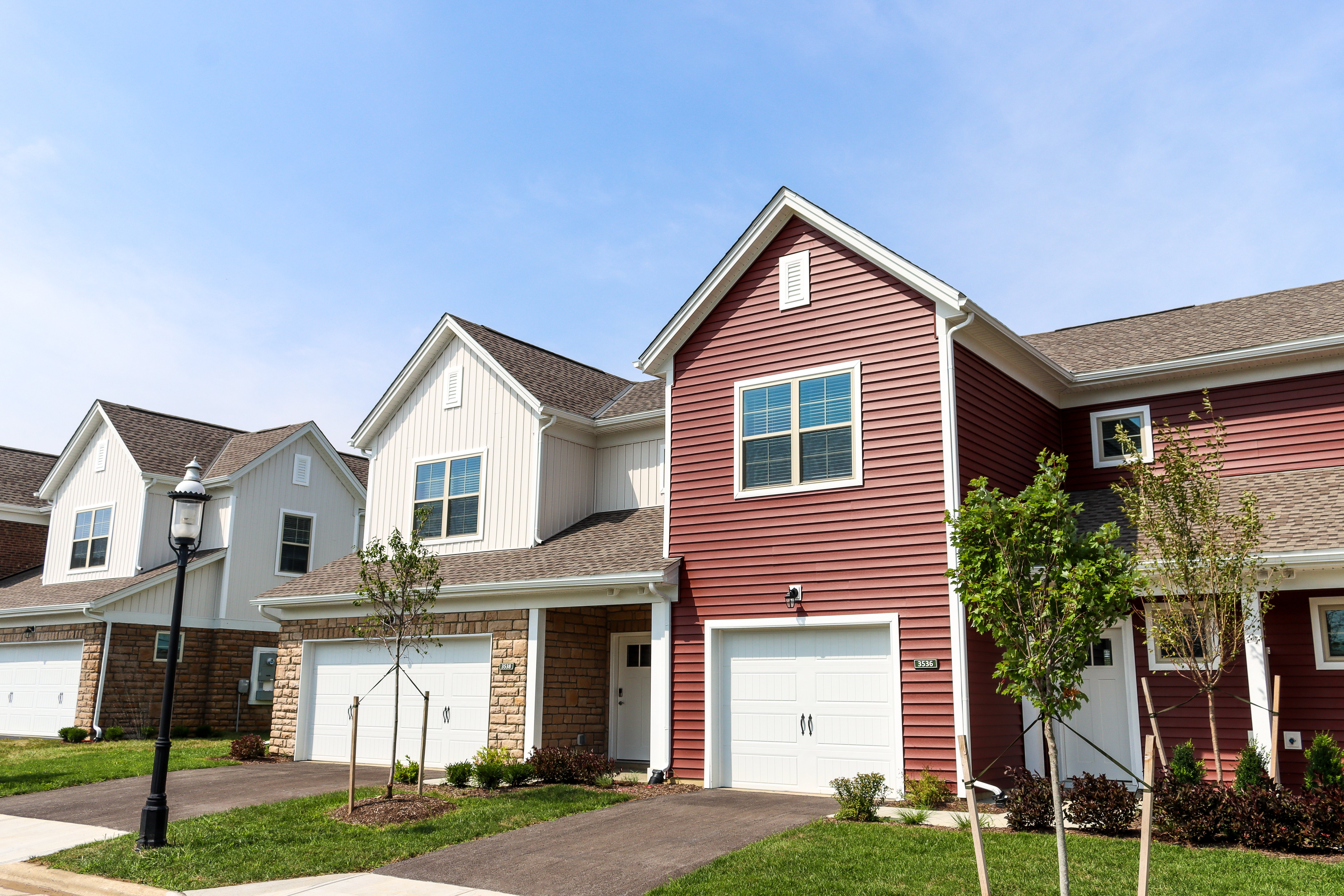  The Strand at Beulah Townhomes in Grove City, Ohio featuring attached garages, private driveways, and modern townhome exteriors.