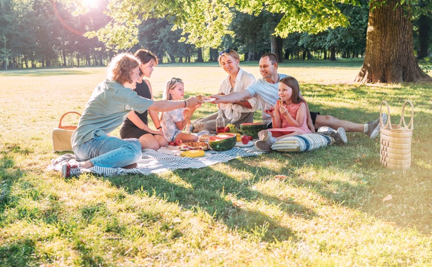 Family enjoying a picnic on a sunny afternoon in a Philadelphia park.
