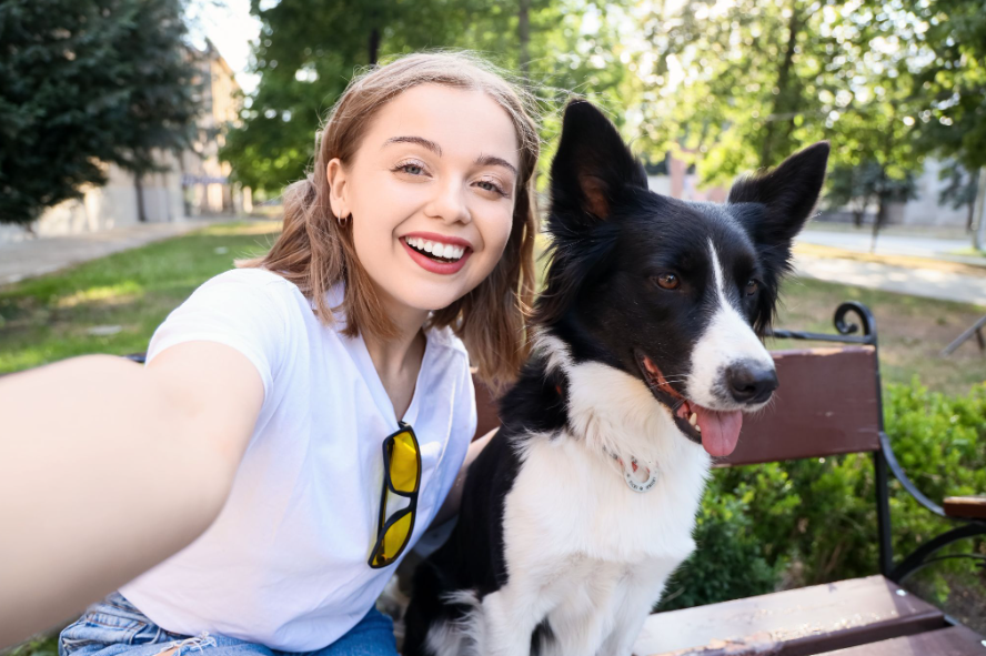 Woman taking selfie with border collie at pet friendly park in Norcross GA