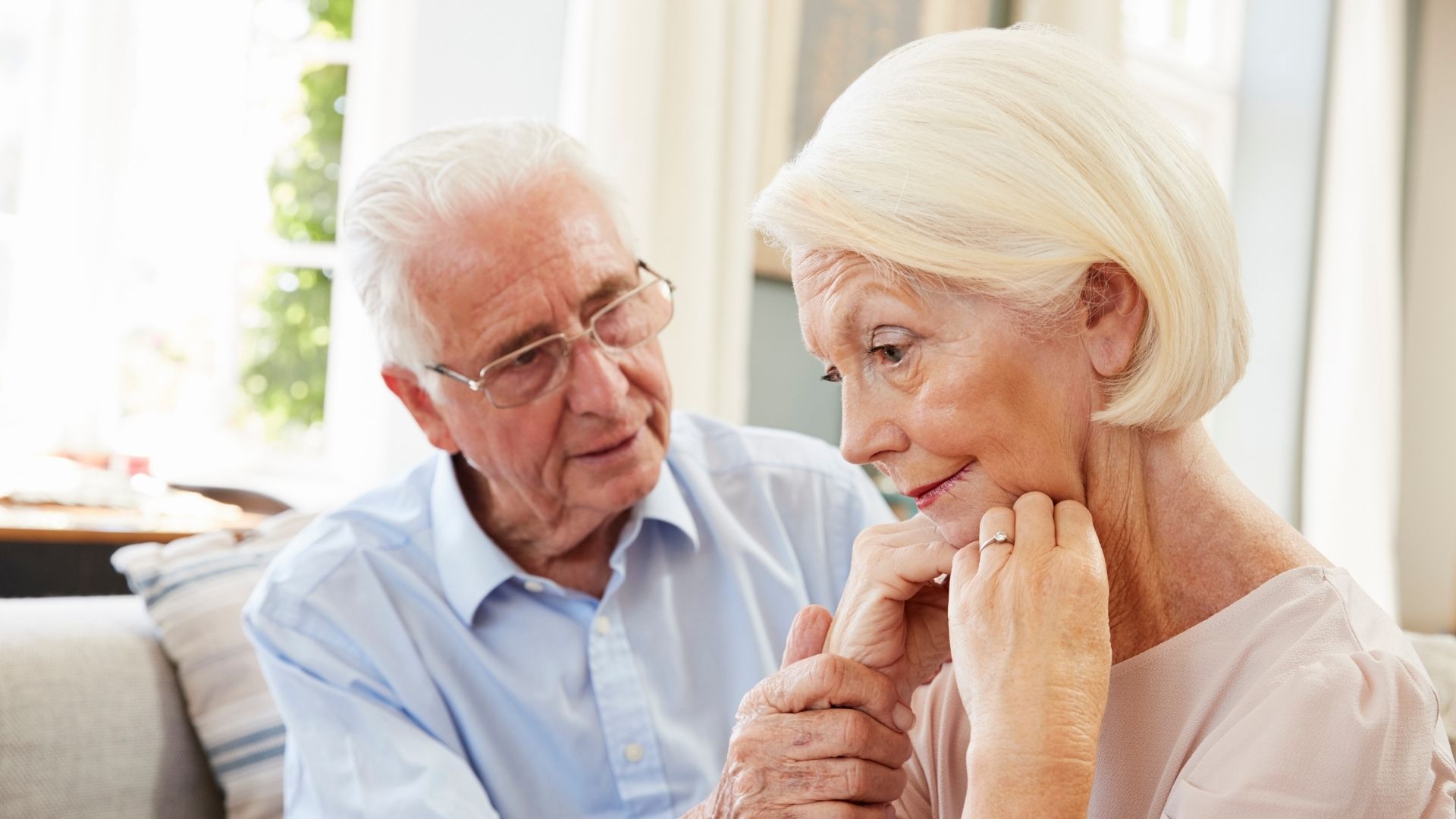 senior husband comforting senior wife with dementia