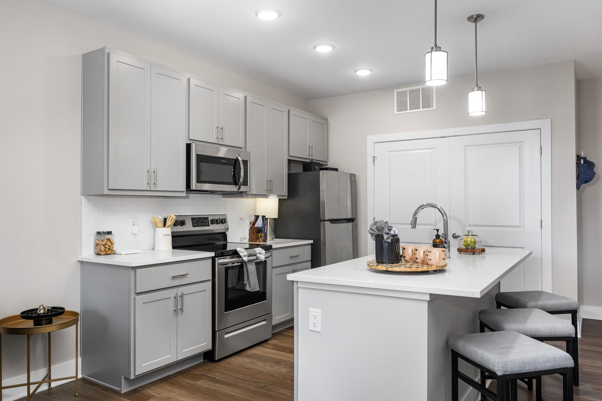 Open concept kitchen at Residences at Topiary Park apartments in downtown Columbus with island and stainless steel appliances.