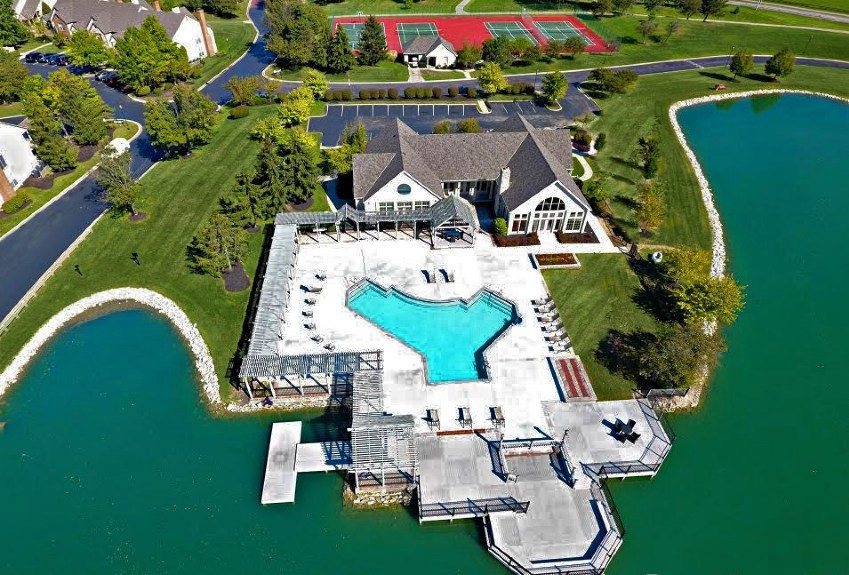 Aerial view of Asherton of Dublin Apartments in Dublin, Ohio featuring scenic ponds, green space, and a peaceful residential community layout.