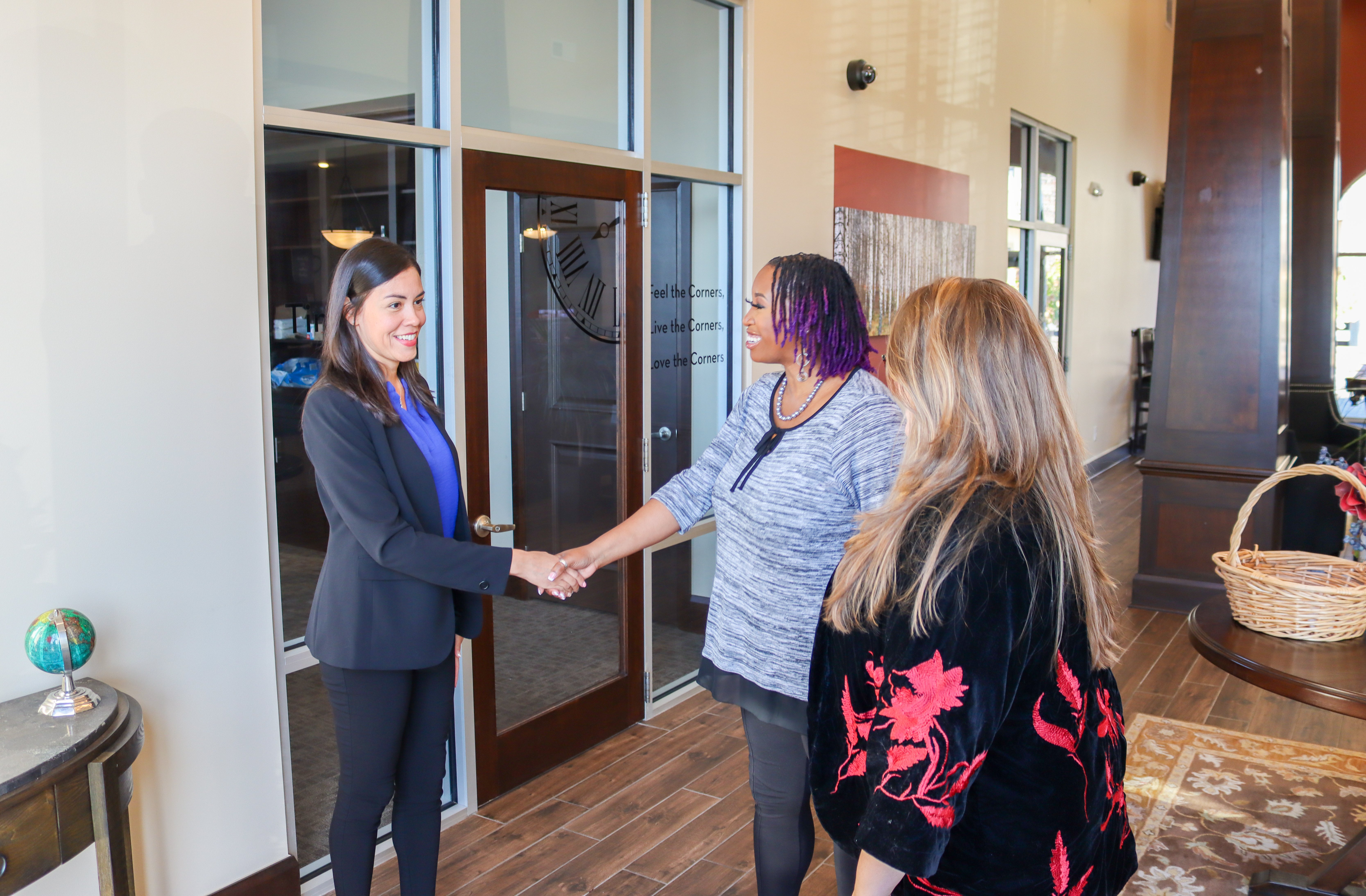 Oakwood team member talking with a resident and reviewing apartment information in the leasing office.