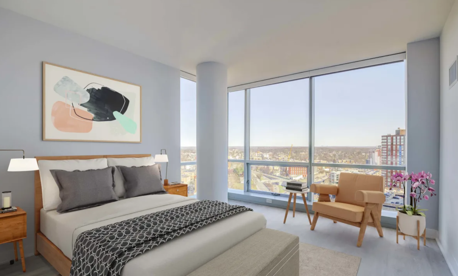 Modern bedroom interior at 3Thirty3 Apartments in New Rochelle featuring floor-to-ceiling windows, city views, neutral decor, and contemporary furnishings
