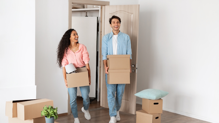 Happy couple walking into their 1 bedroom apartment