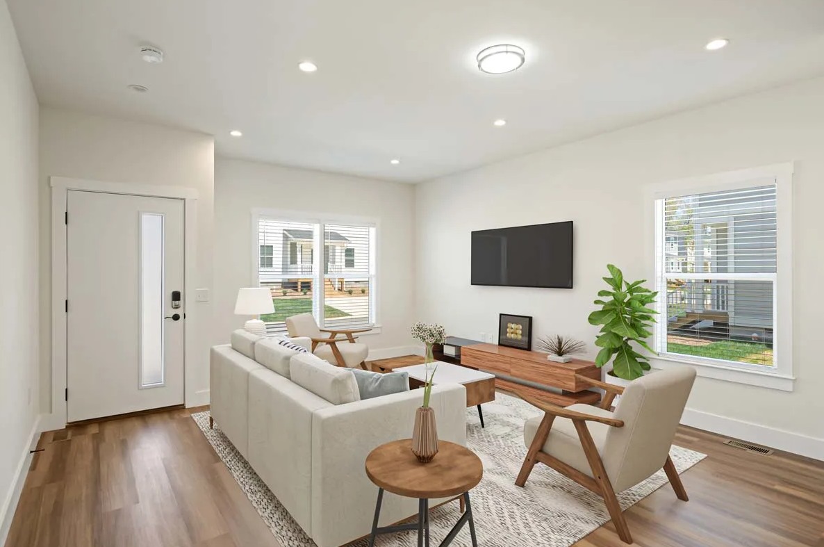 Bright, modern living room with hardwood floors and natural light at Belle Meadow rentals.