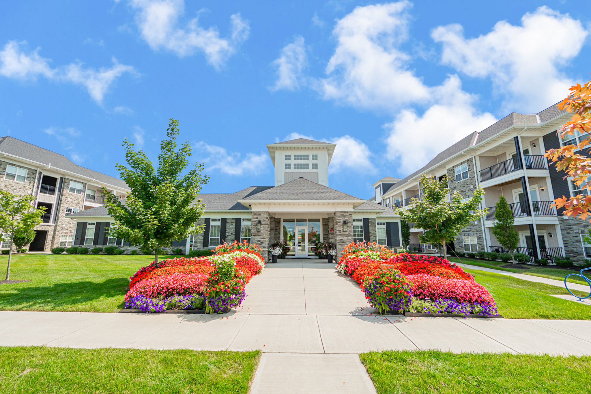Clubhouse exterior at The Edge at Polaris with landscaped entrance and community buildings in Columbus, Ohio.