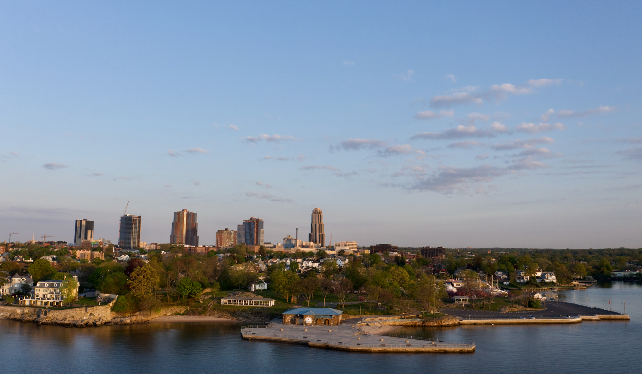 Aerial view of the New Rochelle, New York skyline and waterfront at sunset.