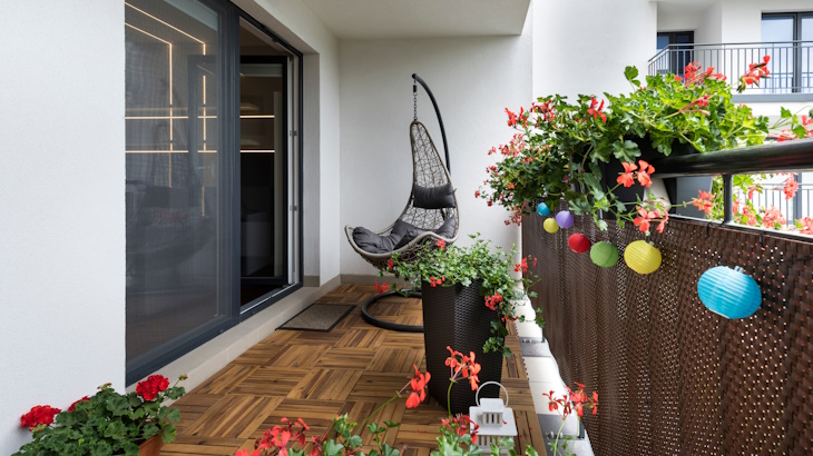 apartment balcony with wood tile flooring a chair and lights