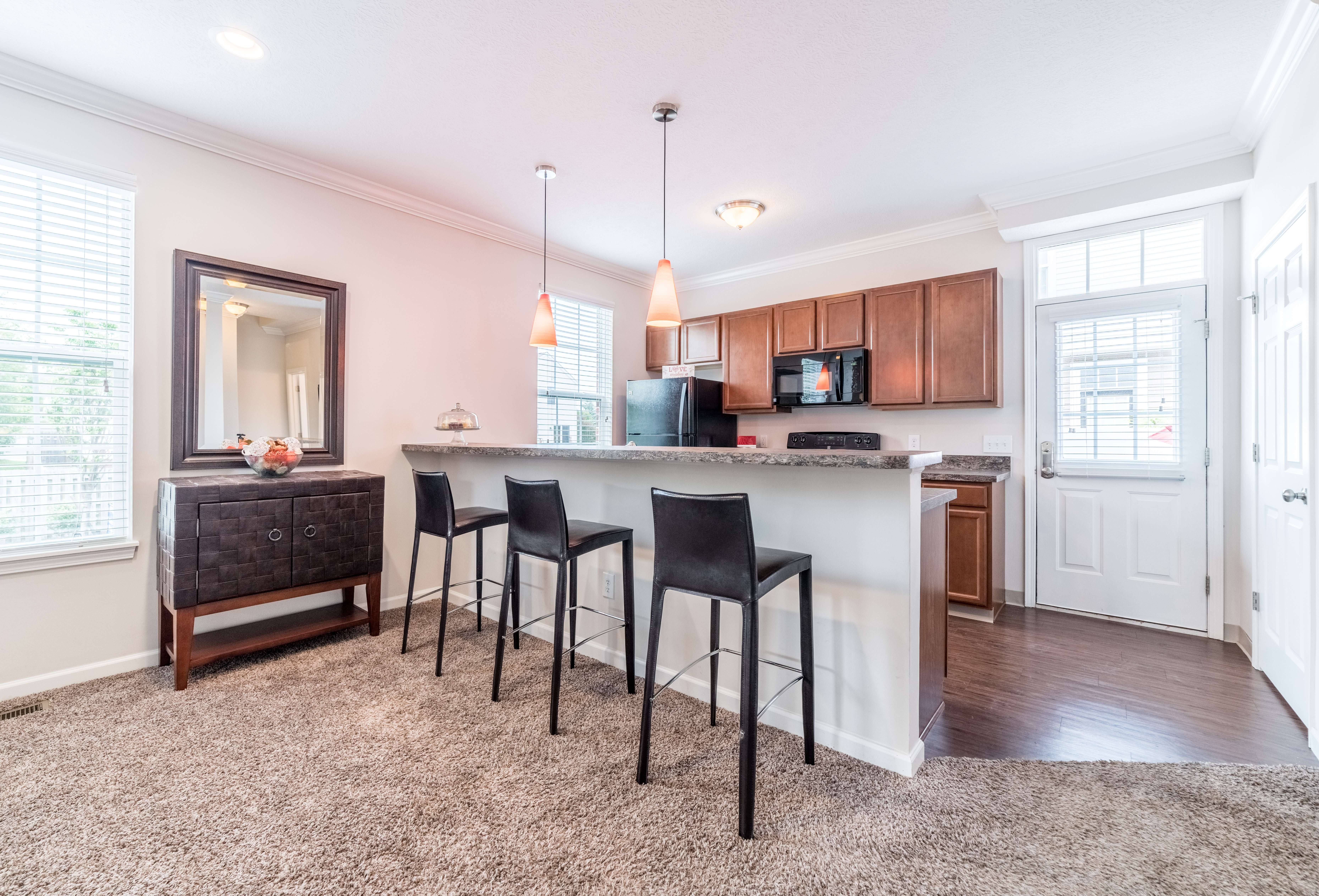Kitchen and breakfast bar at Enclave Village with bar seating and open layout in Columbus, Ohio.