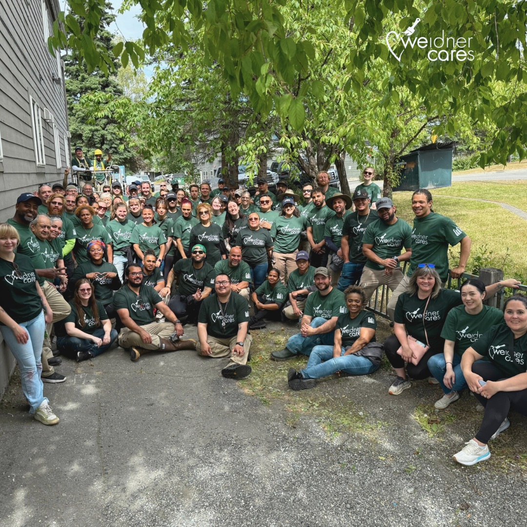The Alaska WeidnerCares team gathering for a photo by the Clare House shelter.