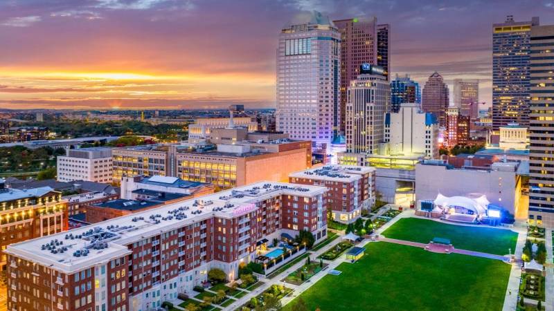 Aerial view of Highpoint on Columbus Commons Apartments in downtown Columbus, Ohio at sunset, overlooking the park and city skyline.