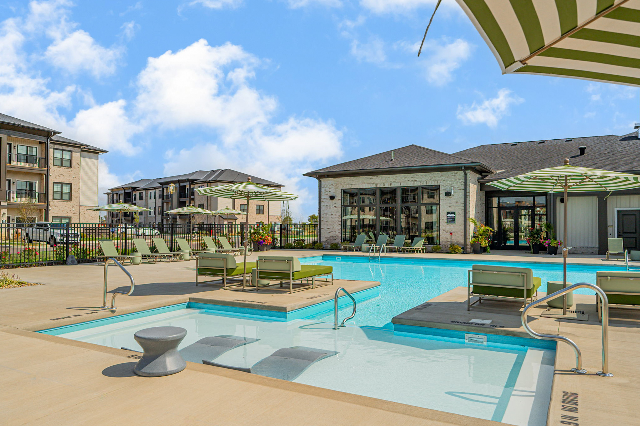 Resort-style pool with lounge chairs, cabanas, and outdoor seating at Club at Woodside in Marysville, Ohio.