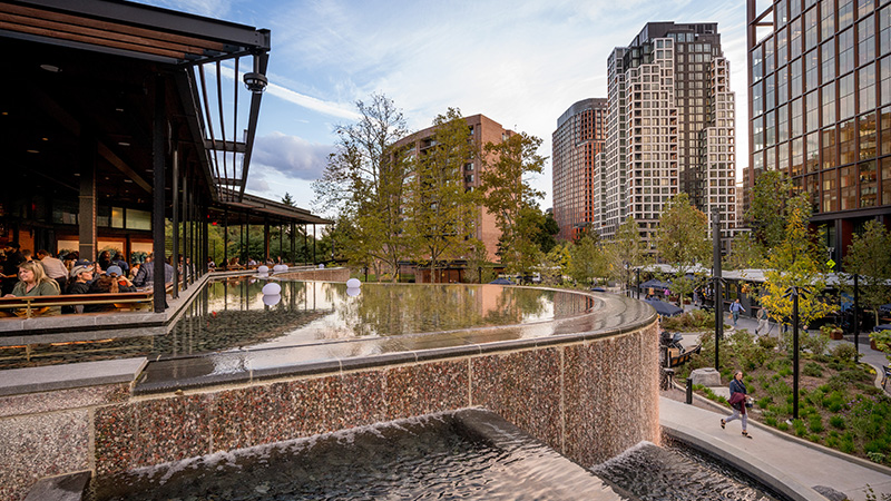 A plaza with a fountain and outdoor dining in National Landing, Arlington, Virginia