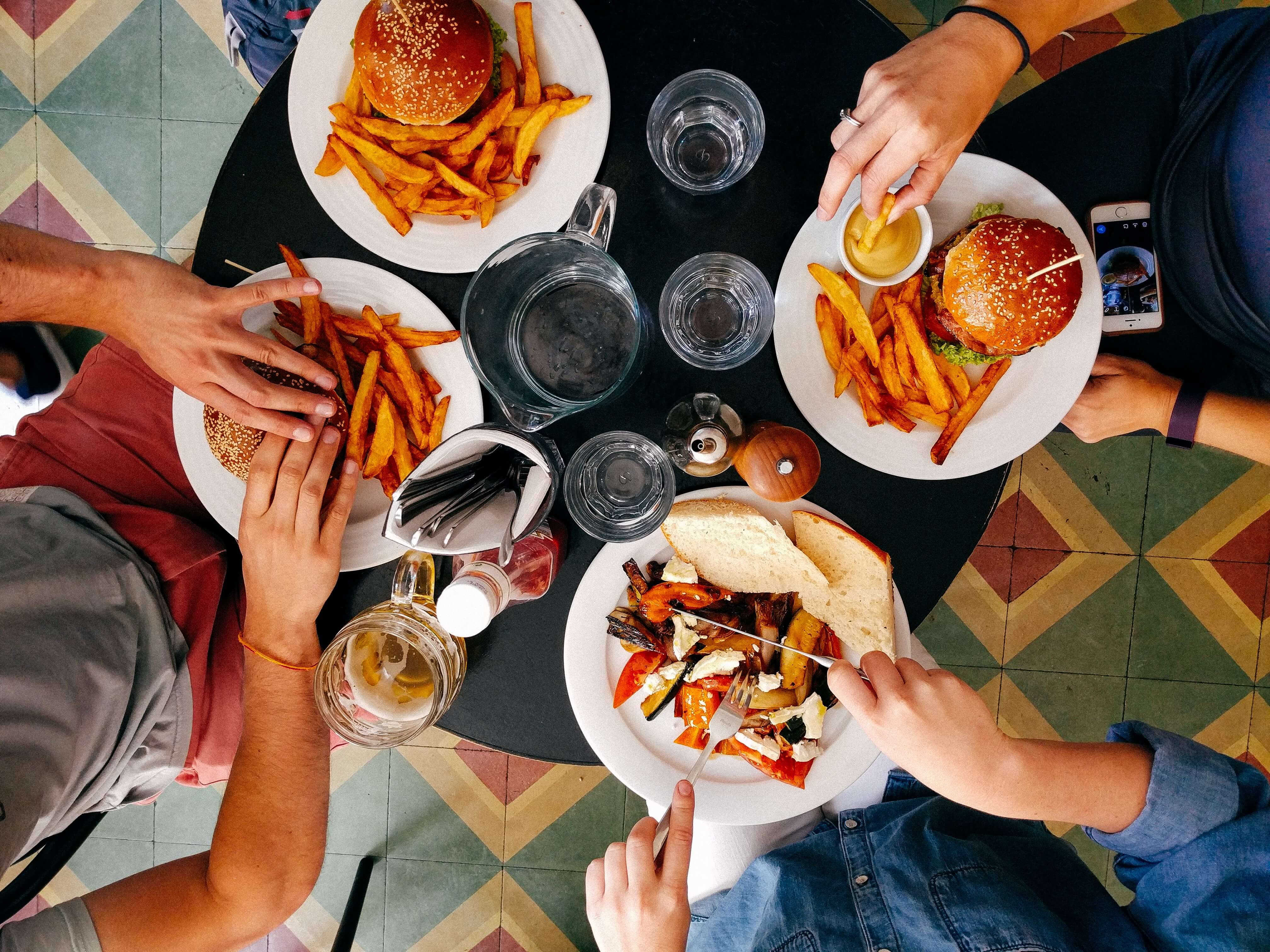 food on a large table with hands
