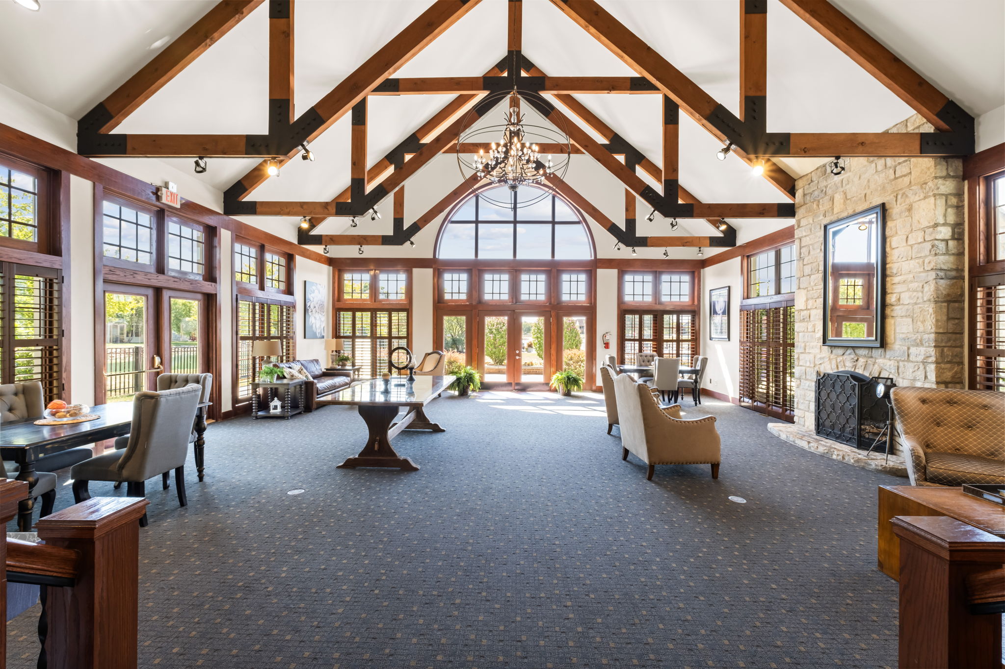 Clubhouse interior at Asherton of Dublin apartments in Dublin, Ohio featuring high ceilings, exposed beams, and community gathering space.