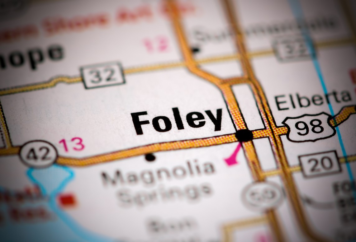 Close-up view of a printed map highlighting Foley, Alabama and nearby highways.