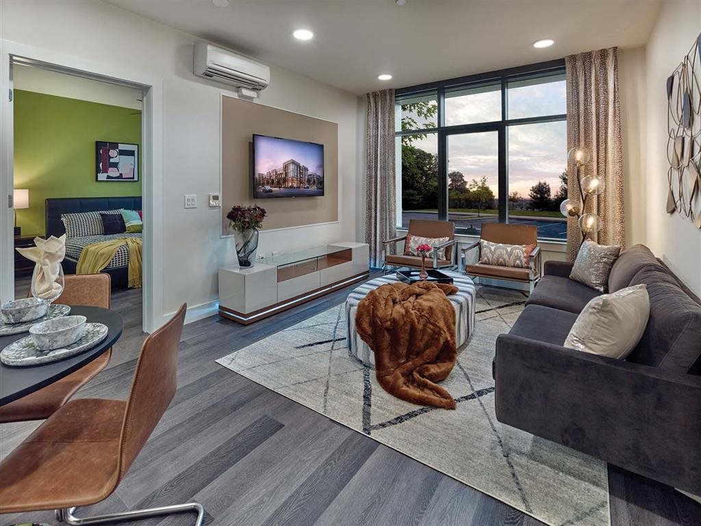 Living room with large windows and scenic views at Vermella Union, Union NJ
