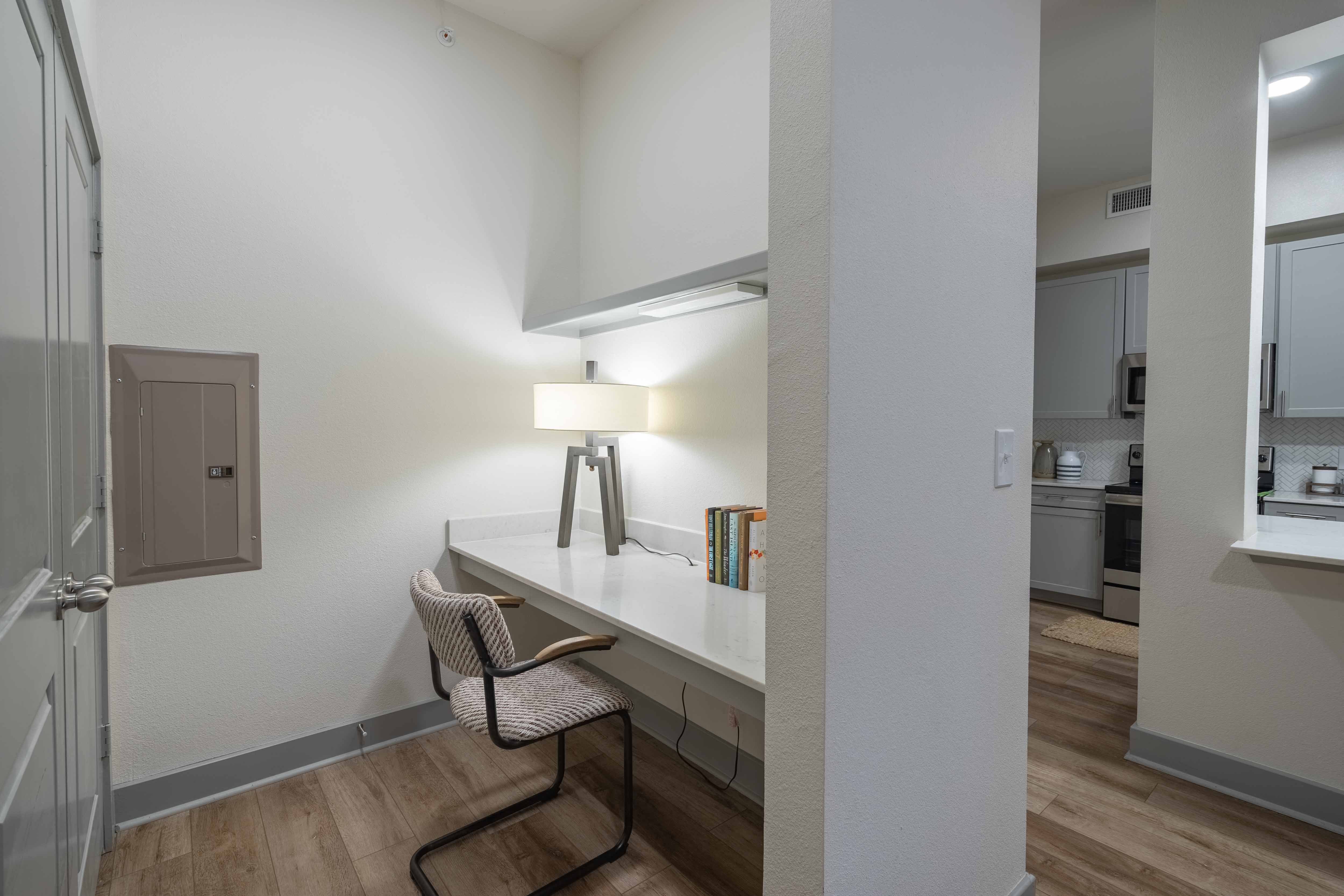 a bedroom with a desk and chair