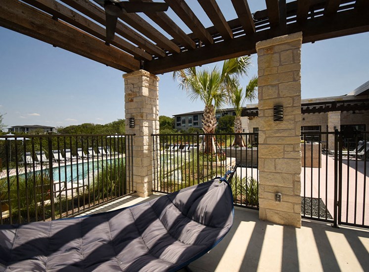Outdoor seating area with hammock and view of pool at Terra, Texas, 78744