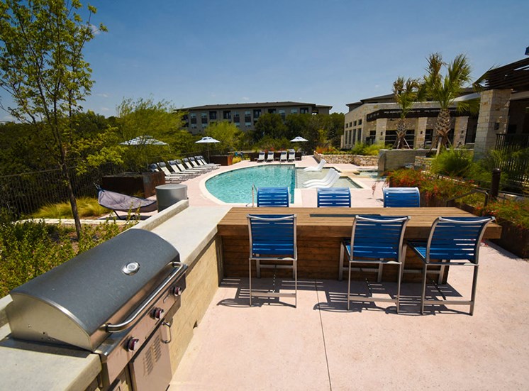 Community pool with BBQ grill and outdoor dining area at Terra, Austin, 78744