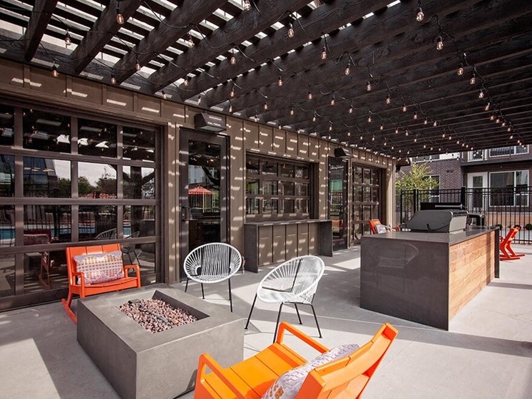 Outdoor courtyard with firepit, seating area and barbeque grill