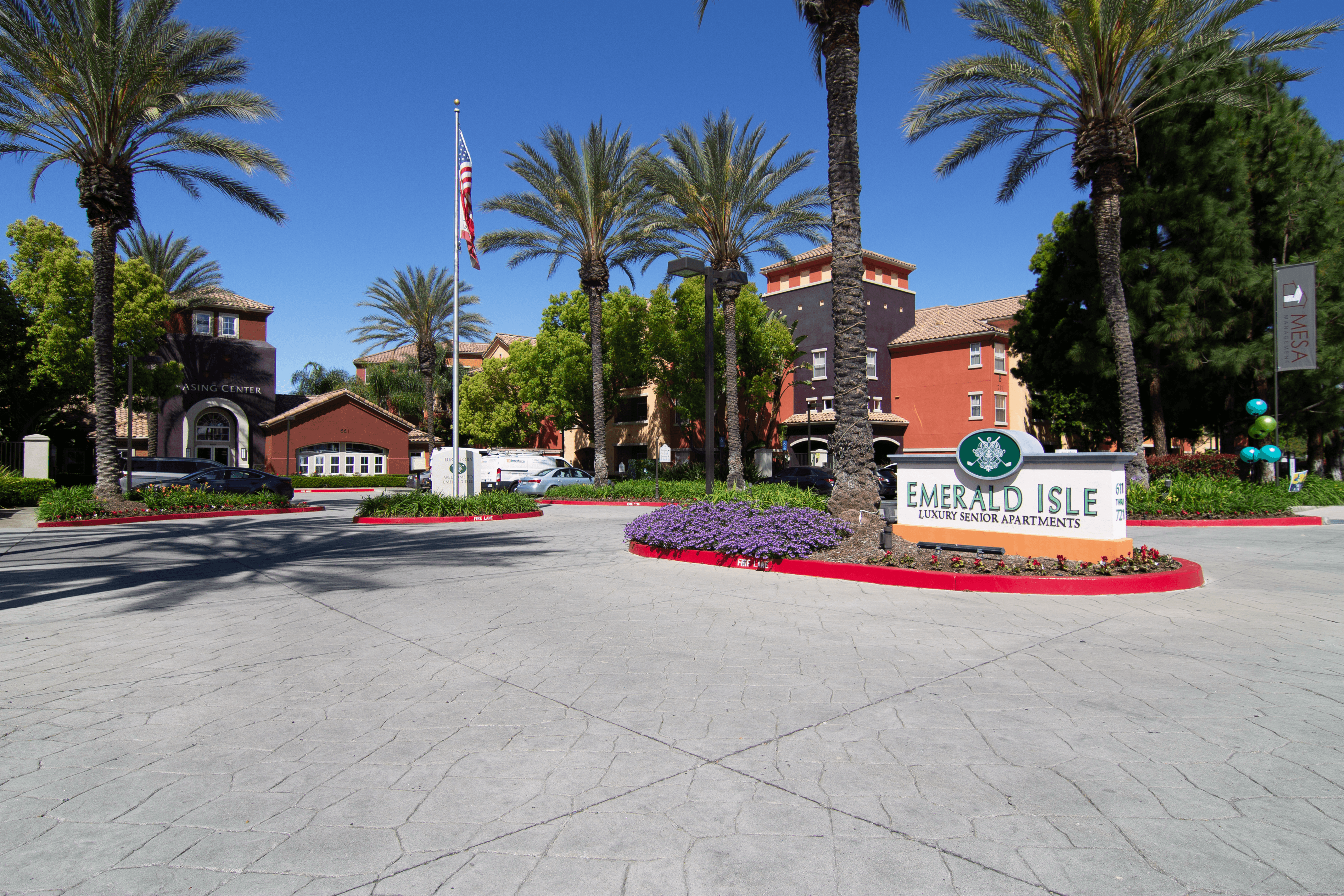 A sign that says Emerald Isle in front of some buildings.,A sign that says Emerald Isle in front of some buildings.