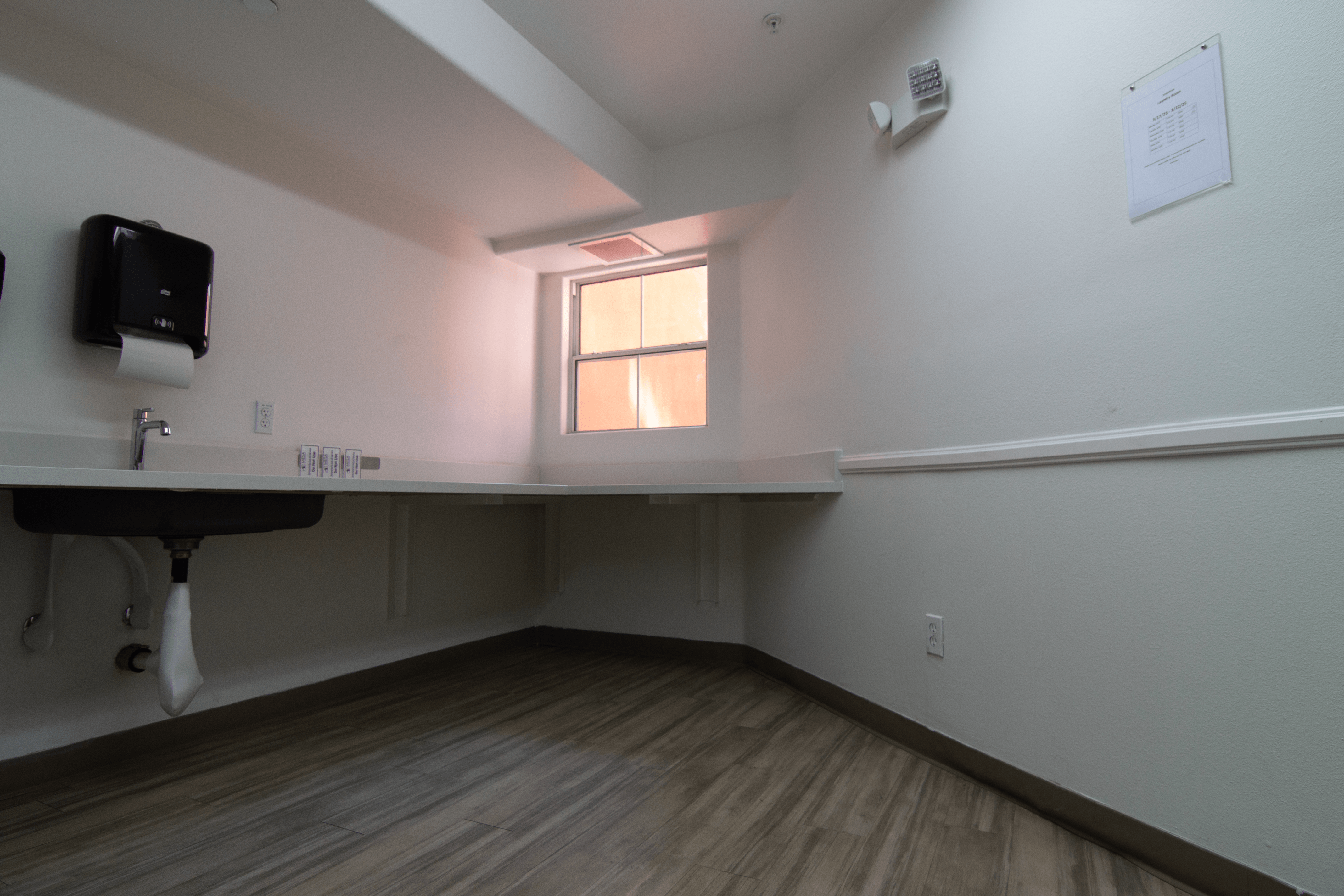 A room with a desk and a window.