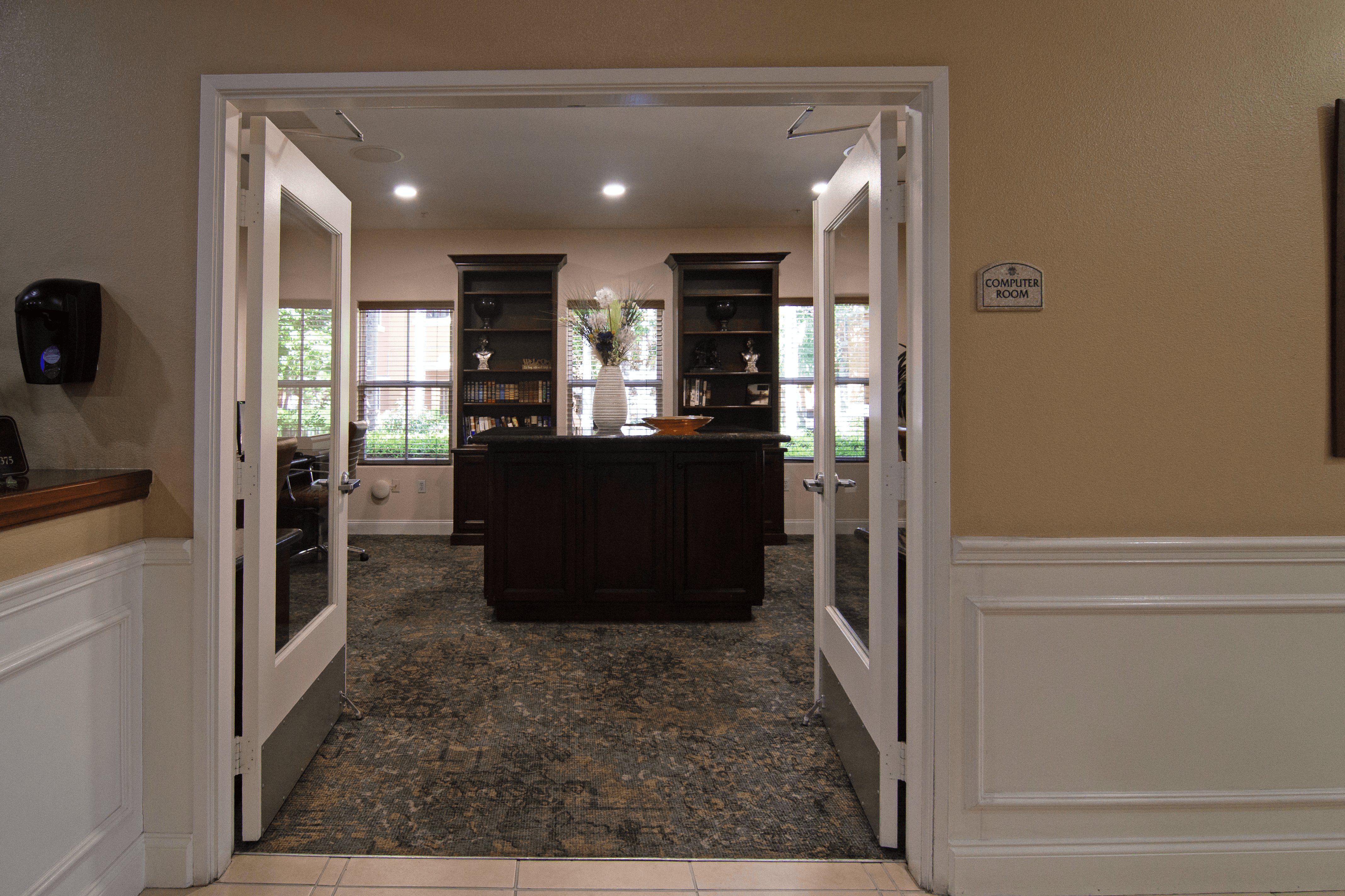 A room with a brown counter and a white door.,A room with a brown counter and a white door.